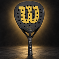 Wilson Defy Pro racket on dark gold studio background